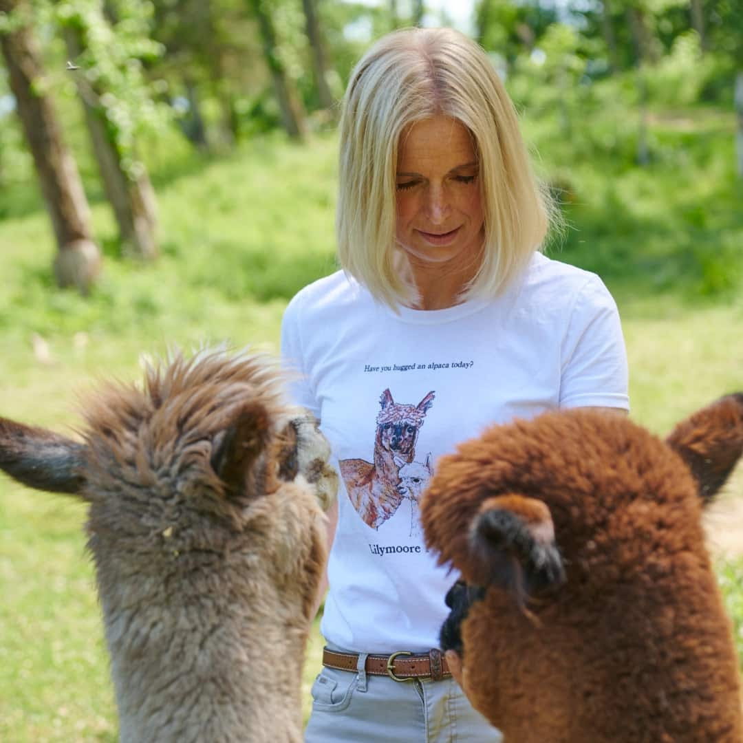 Diana feeding some alpacas